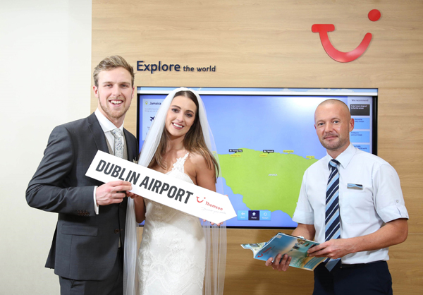 December 2016 - Picture by Darren Kidd / Press Eye. Rebecca Maguire and Dan Laird are pictured looking at the destination wedding venues and honeymoon offers to Mexico and Jamaica at the Thomson store at Castlecourt Shopping Centre in Belfast – recently recognised as the best NI Multiple Retail Agency Branch 2016’ at the Northern Ireland Travel & Tourism Awards 2016
